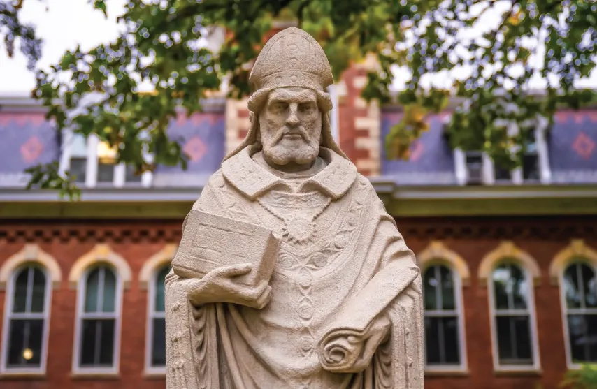 A stone statue of Saint Ambrose of Milan outside.